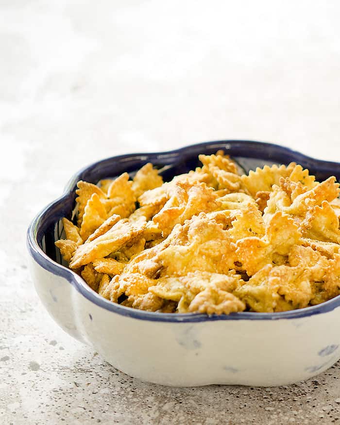 Air Fryer Bow Tie Pasta Chips in a flower-shaped bowl on the table