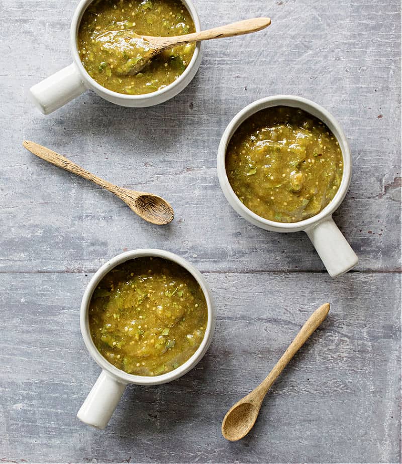 Salsa Verde in 3 ceramic dishes with wooden spoons