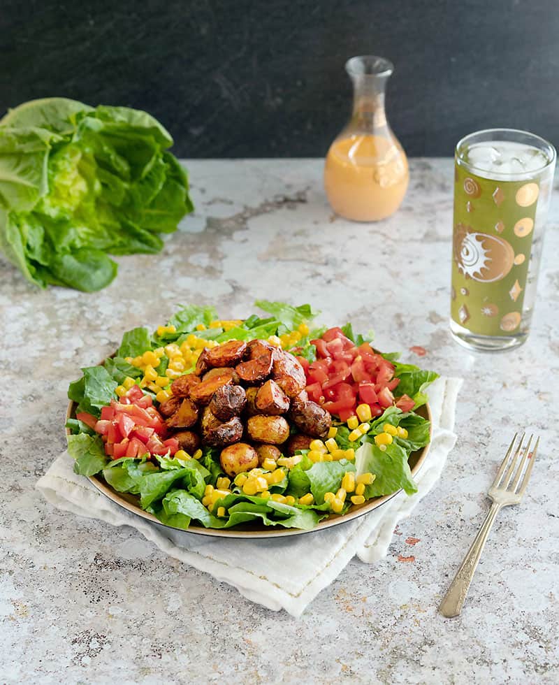 Image of salad, dressing, and drink