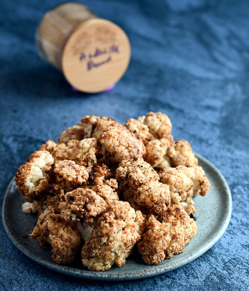 Air Fried Andouille Cauliflower on a blue ceramic plate