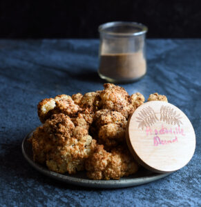 Air Fried Andouille Cauliflower on a blue ceramic plate