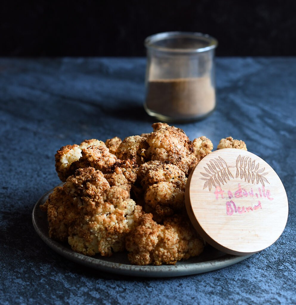 Air Fried Andouille Cauliflower on a blue ceramic plate