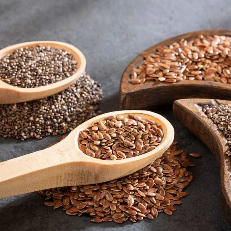 Whole flax seeds in a wooden spoon