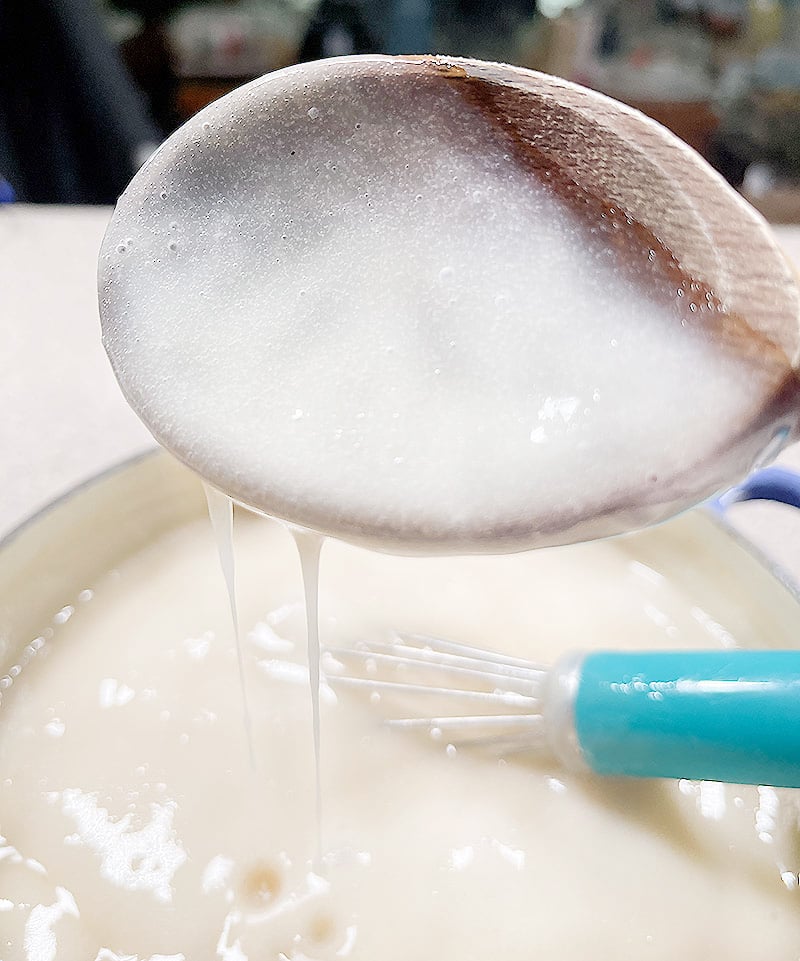 Wooden spoon coated with the thickened pudding mixture.