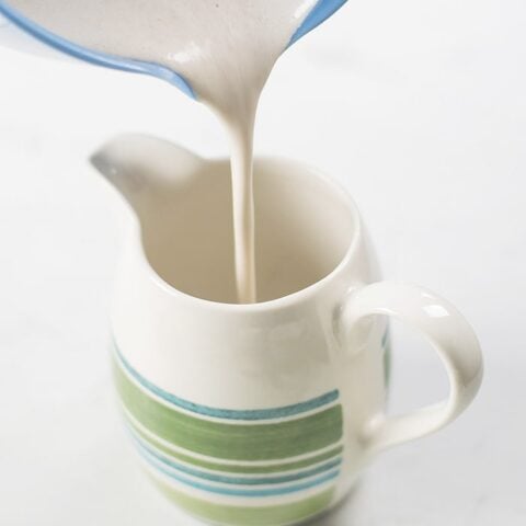 cashew almond vegan creamer poured on a mug