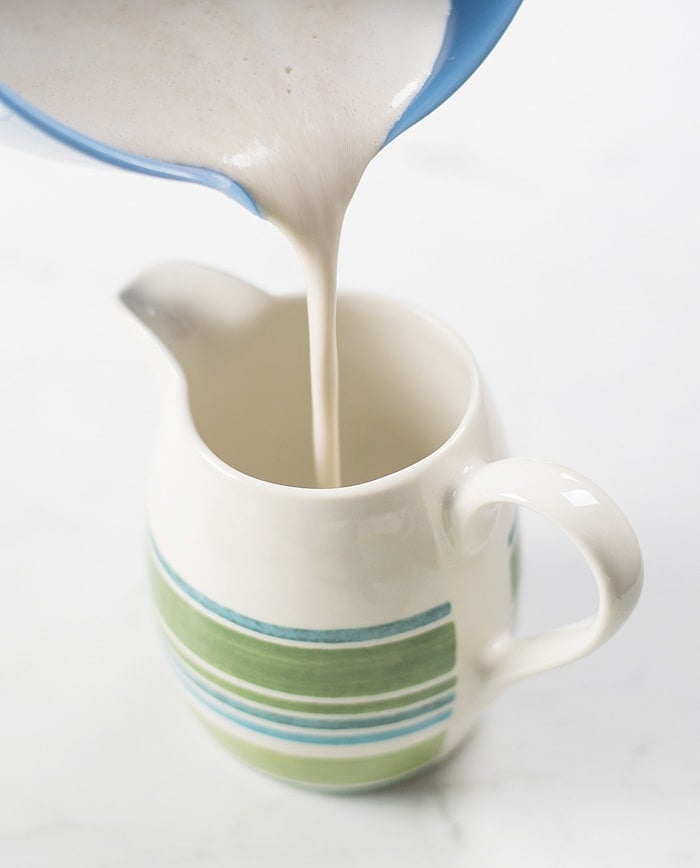 Cashew almond vegan creamer poured on a mug