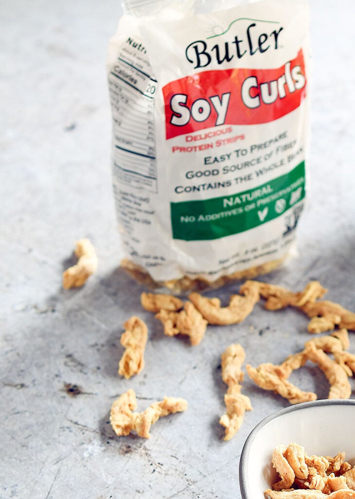 Bag of Butler soy curls with dried soy curls scattered about