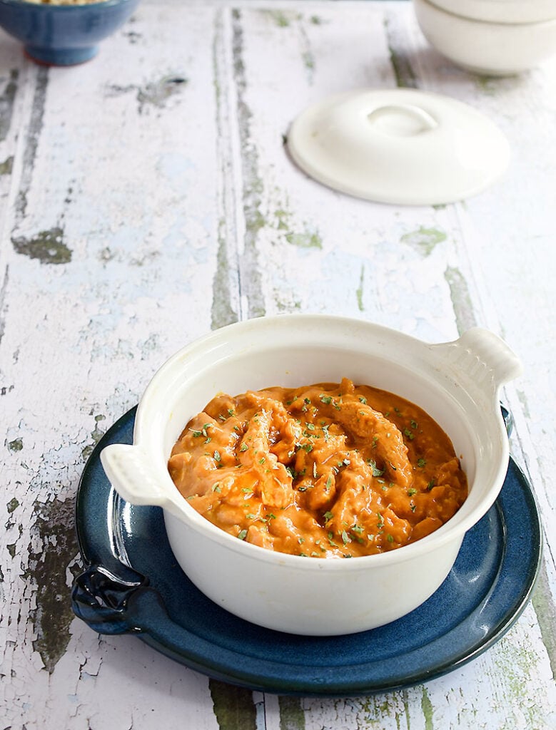 Vegan butter chicken made with soy curls in a white casserole dish
