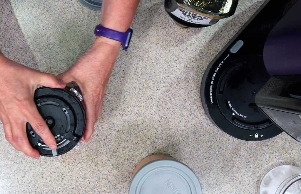 Kathy putting the Ninja Creami Breeze lid on the pint contianer.