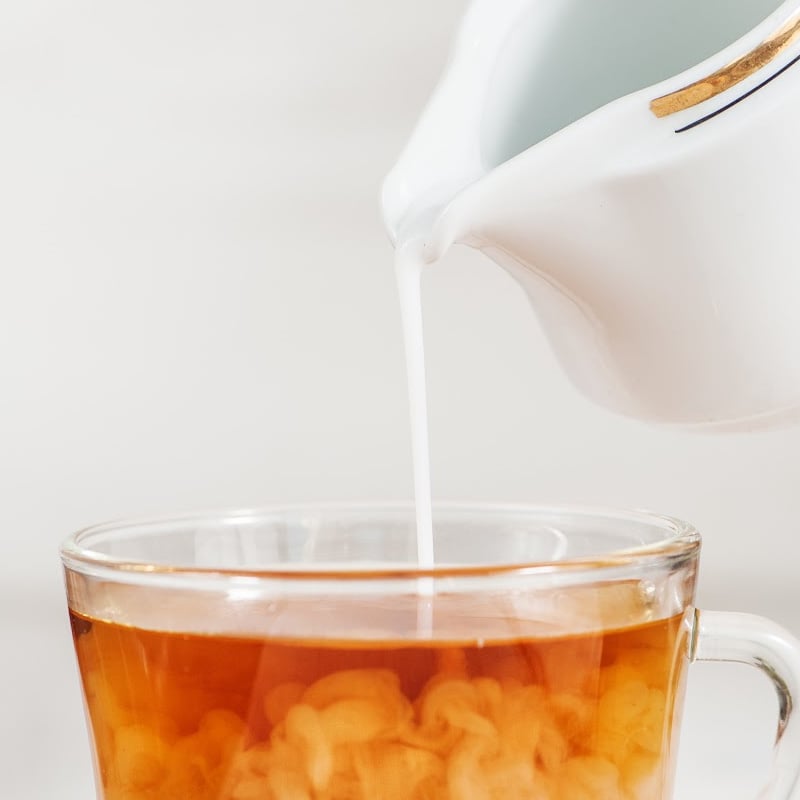 Vegan Creamer being poured into a tea