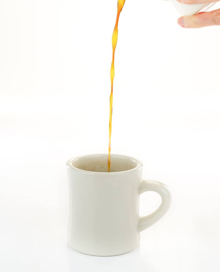 Coffee pouring into a white mug