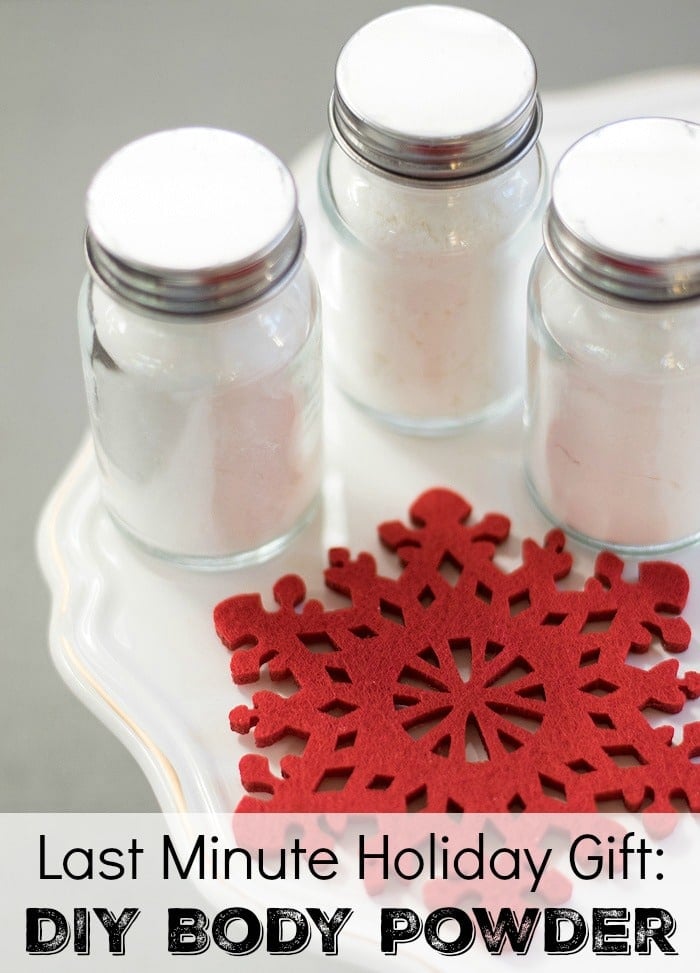 DIY Body Powder stored in three glass bottle jars underneath a stoned white plate with Christmas snowflakes decor