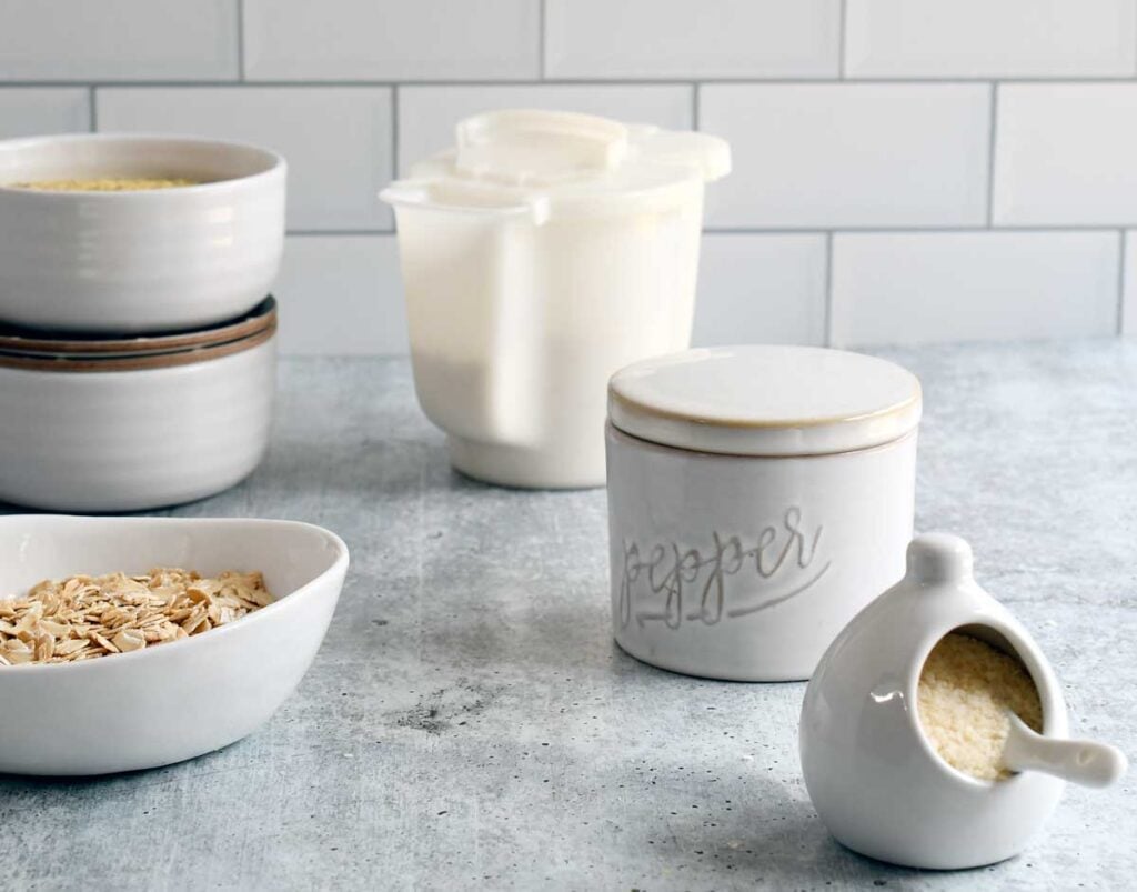 The gravy mix ingredients in small bowls on a concrete counter top.