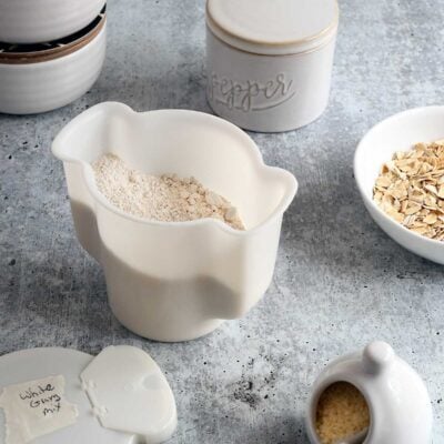 Homemade vegan country white gravy mix in a white tupperware contianer.