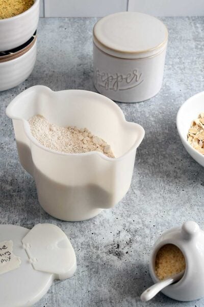 Homemade vegan country white gravy mix in a white tupperware contianer.