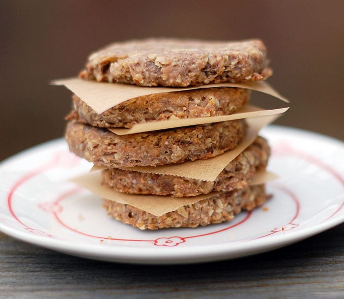 Round banana dog biscuits piled on top of each other with parchment in between served on plate 