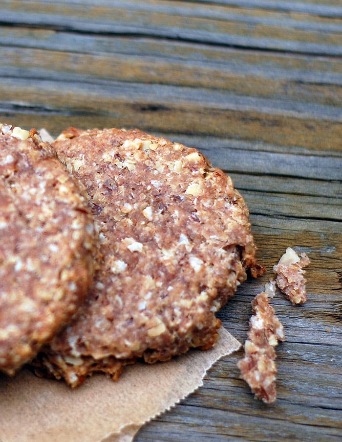 Banana Vegan Dog Biscuits on parchment sitting on a wooden surface