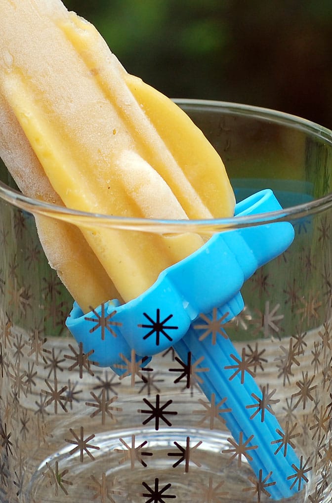 Vegan Mango Lassi Popsicles on Tovolo Rocket Ice Pop Mold Popsicle Maker inside a big round glass