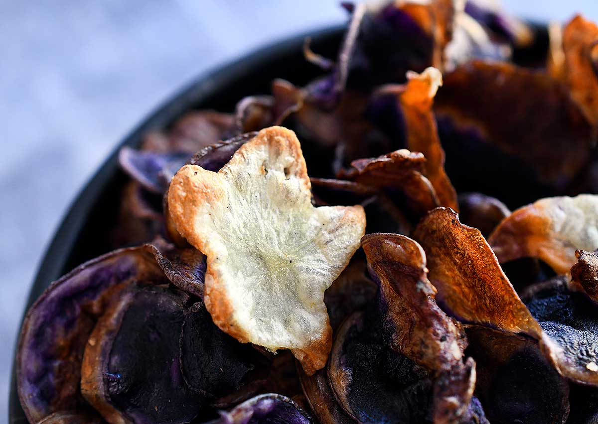 Cut out ghost mini potato chip on top of purple potato chips made int he air fryer.