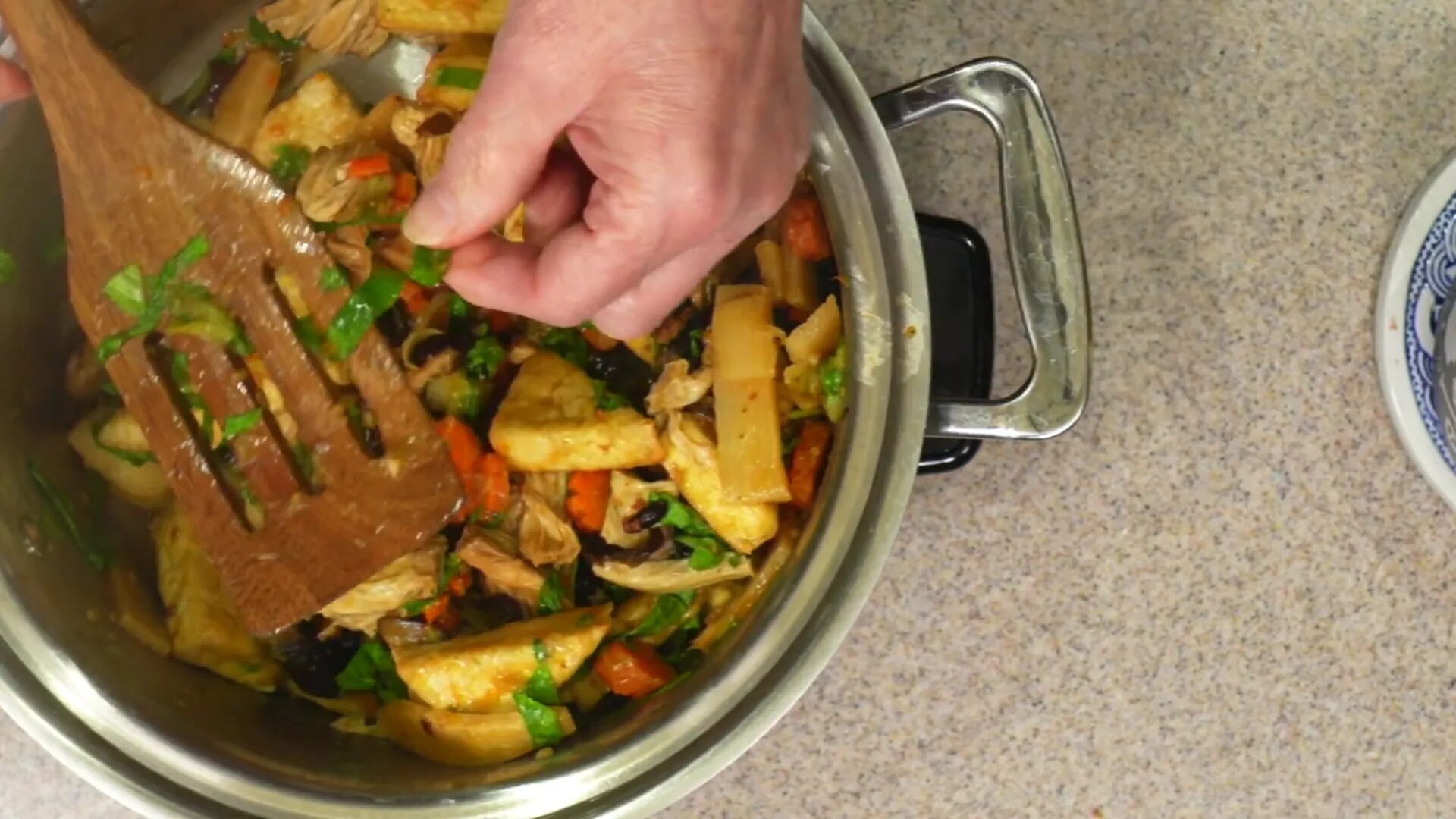 Mixing in the tofu and bok choy greens