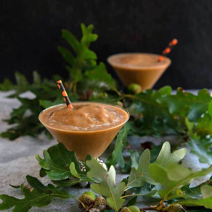 Frozen pumpkin spice coffee in pumpkin stemmed martini glass