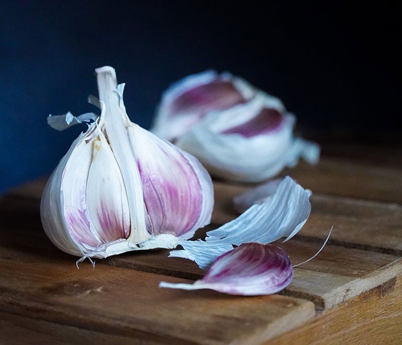 Purple garlic on a wooden table