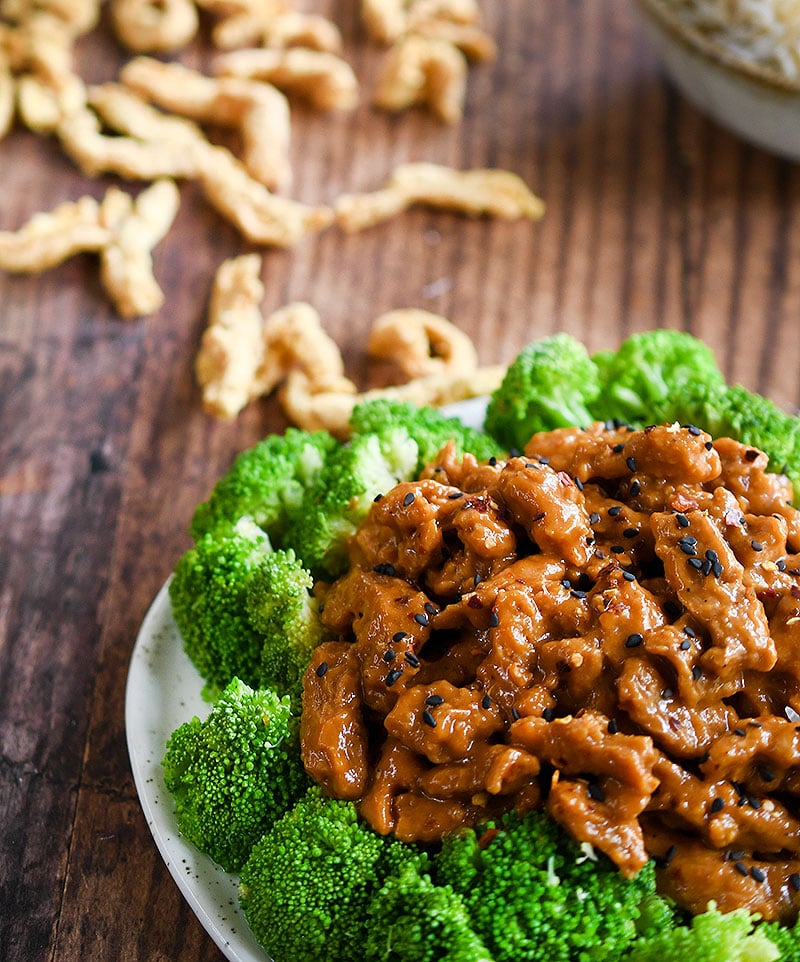 Dry soy curls on a wooden table with General Tso
