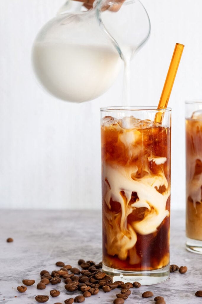 Cold brew coffee with oat milk in tall glasses