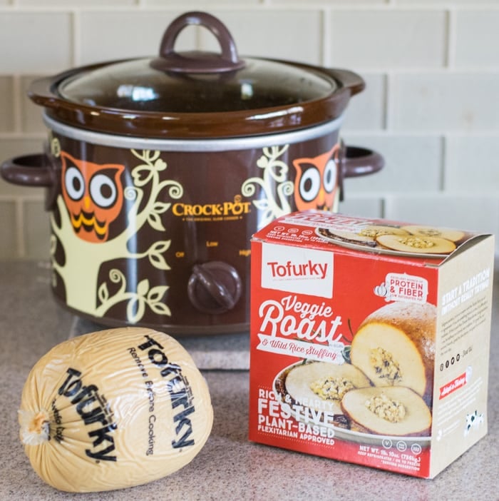 Tofurky veggie roast in front of an owl borwn slow cooker.