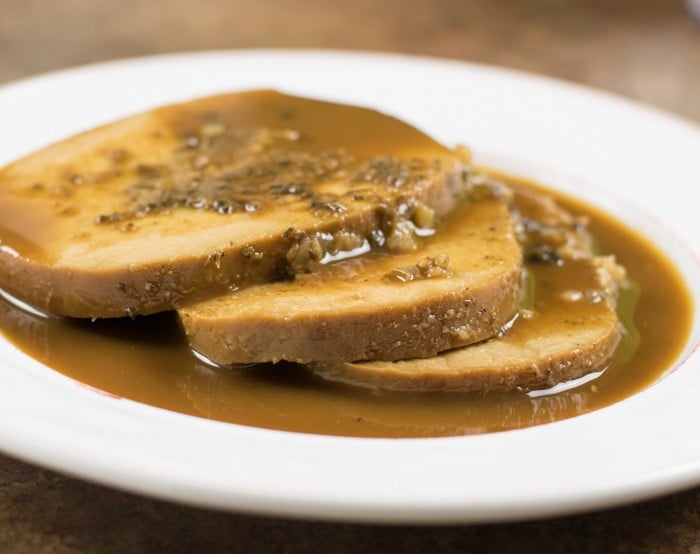 Slices of Tofurky covered in gravy.