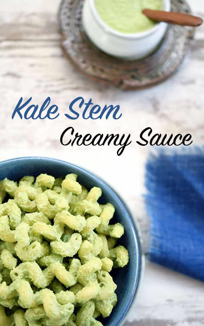 Kale Stem Creamy Pasta Sauce on macaroni served in a blue ceramic bowl with another white bowl of sauce on the side