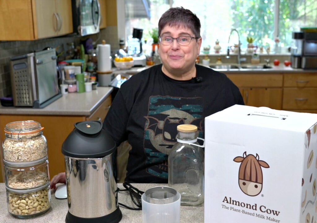 Kathy with the almond cow, a tower of ingredients, ready to make some oat and cashew milk.