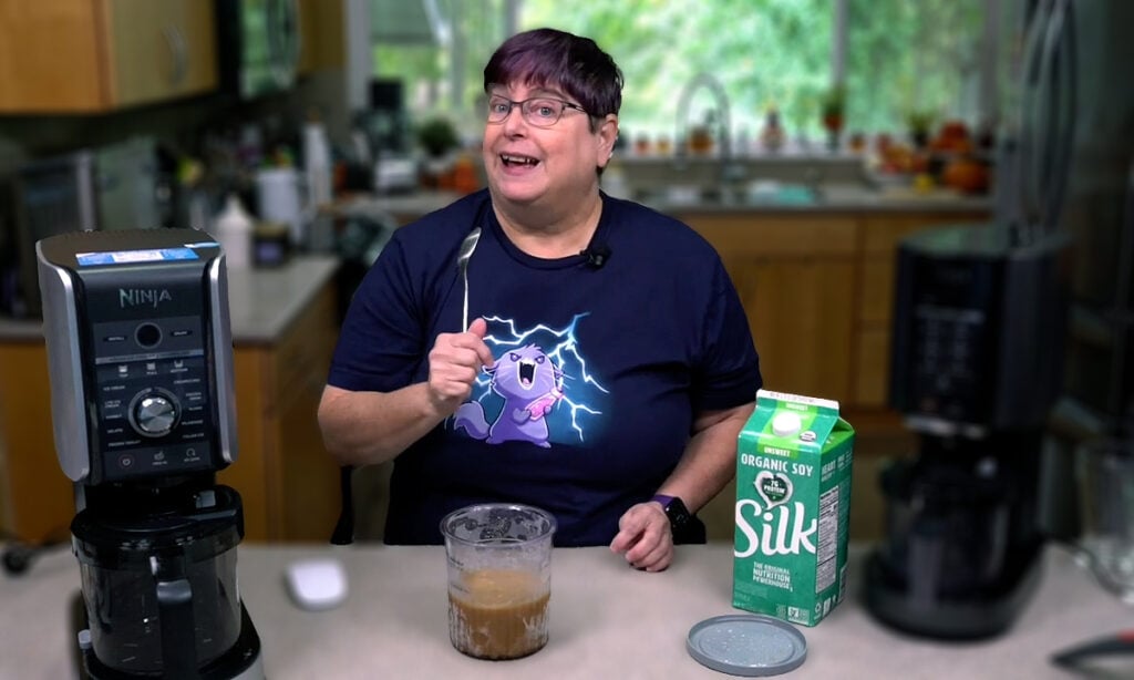 Kathy holding a spoon after flattening out a hump in the Creami pint.