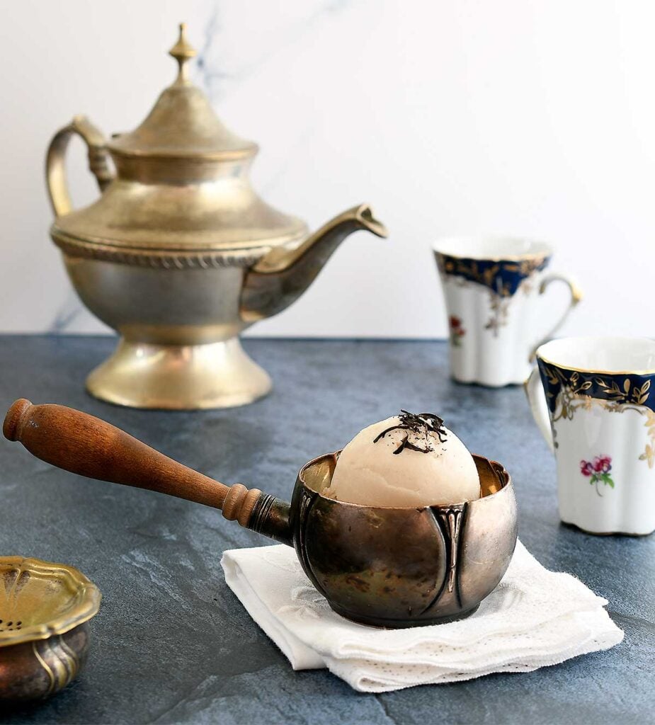 Earl grey tea with vanilla vegan ice cream in a silver bowl.