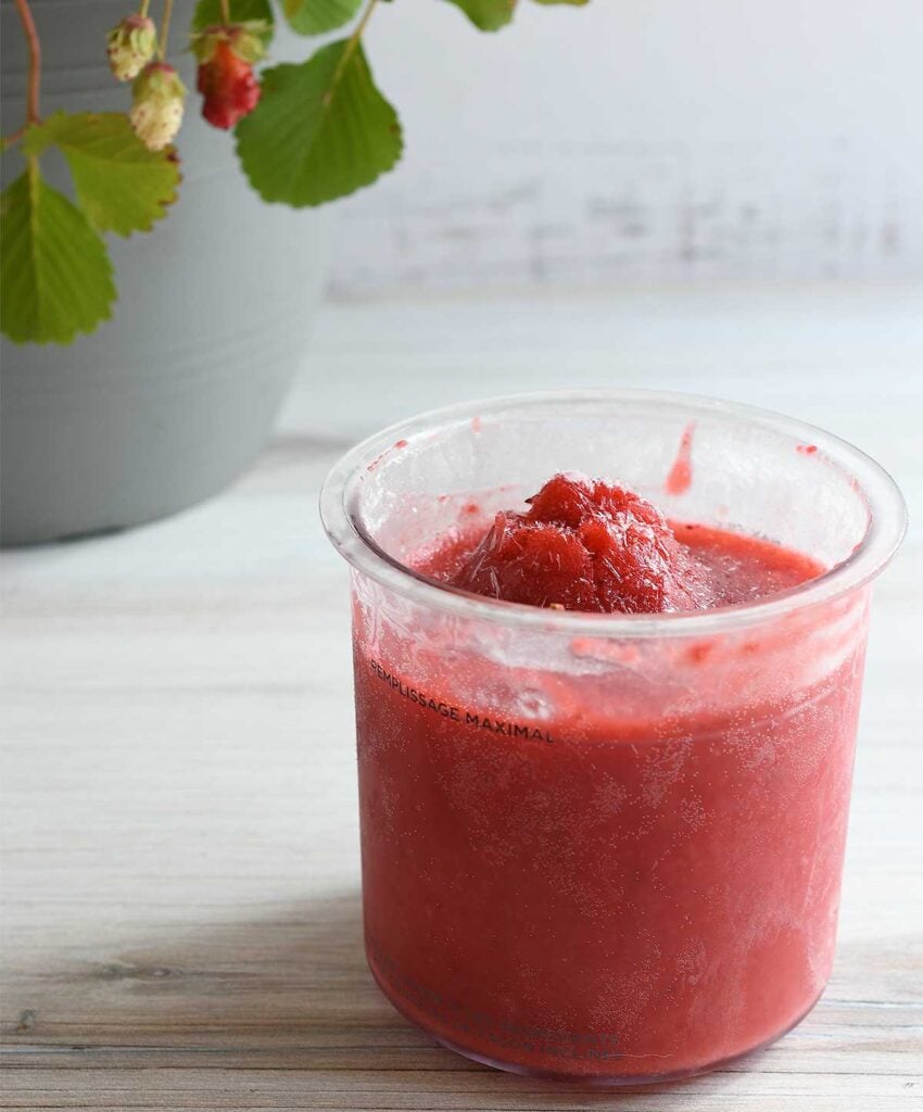 Strawberry ice cream in a Ninja Creami pint with a hump.