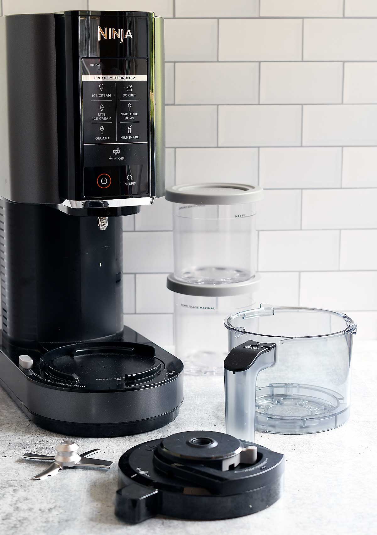 What's included in the Ninja Creami Box? The main machine, the outer bowl and lid, the metal paddle, and pints with lids.
