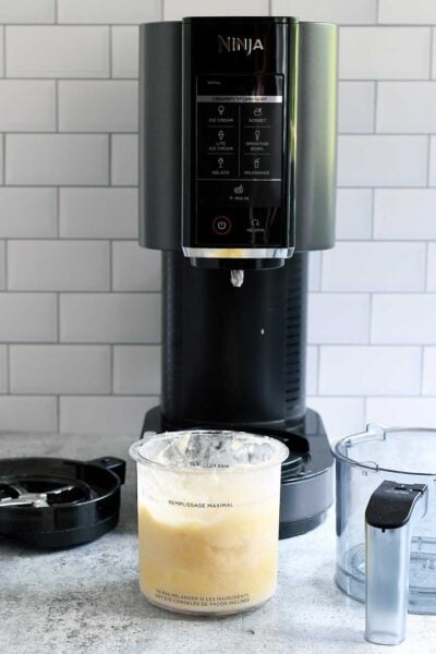 Ninja Creami with a pint of pineapple sorbet ready to spin.