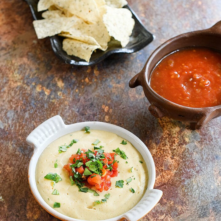 vegan queso made with rolled oats with salsa and chips