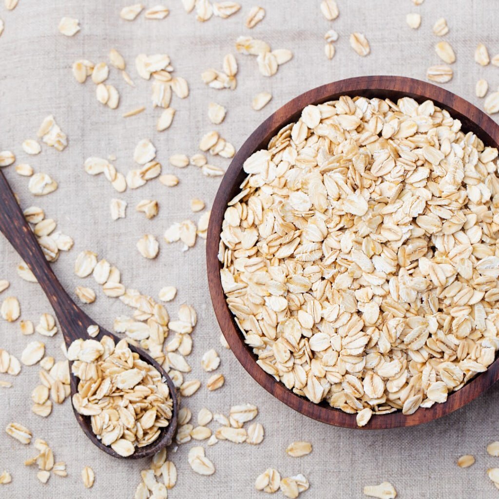 Rolled oats on a wooden spoon and bowl