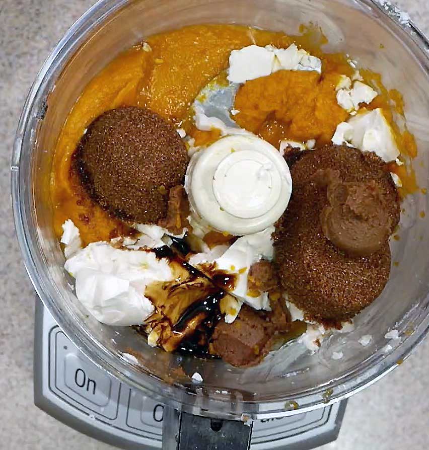 All the butternut squash pie ingredients in the food processor bowl.