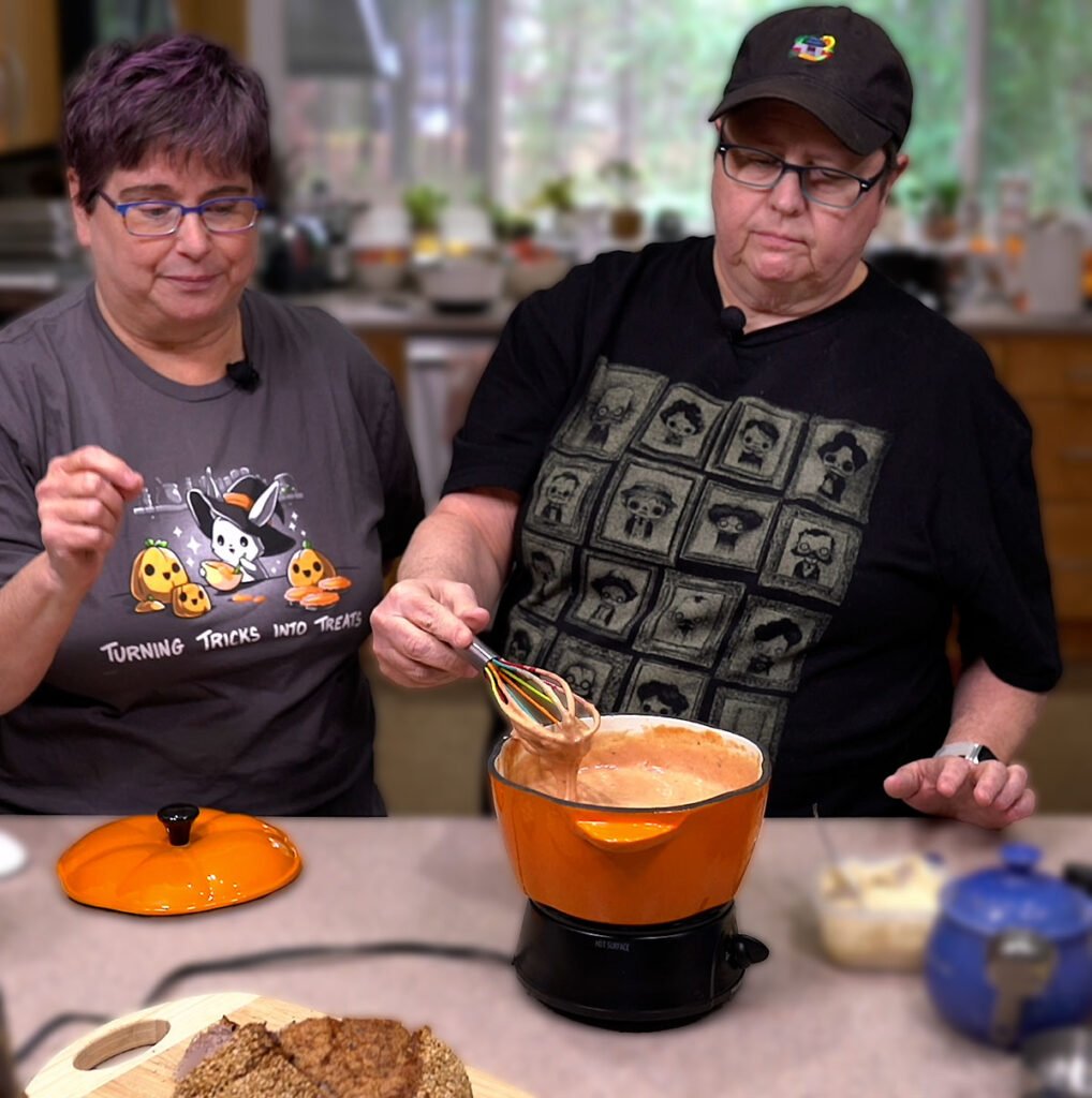 Cheryl and Kathy stirring in the crushed tomatoes to the vegan fondue