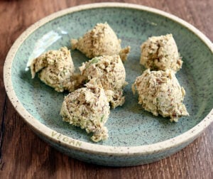 Portioned out matzo balls on ceramic plate.