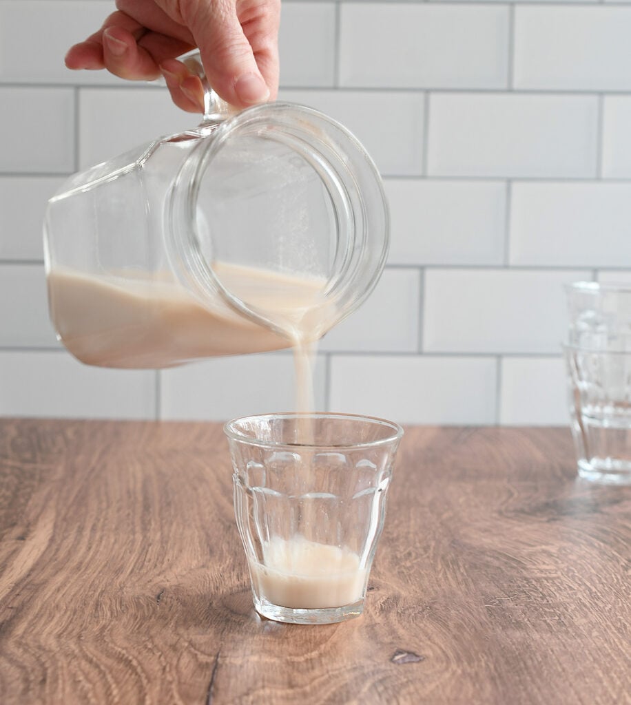 Pecan milk pouring into a glass.