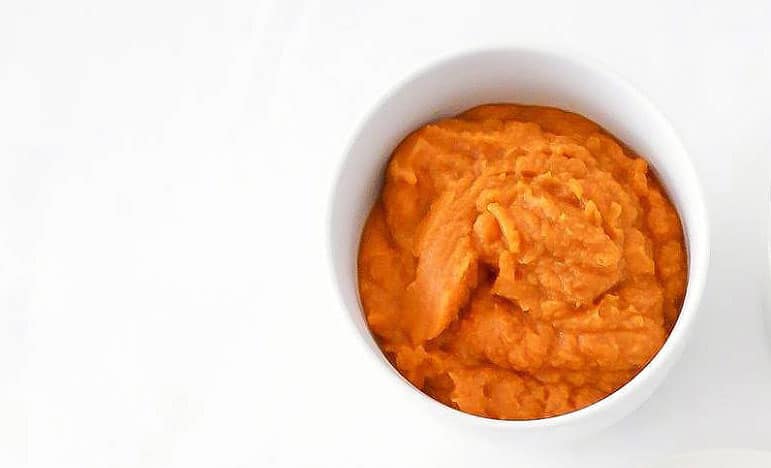 A white bowl of pumpkin puree