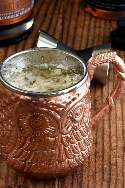 Pumpkin spice cocktail with rum in a bronze owl mug