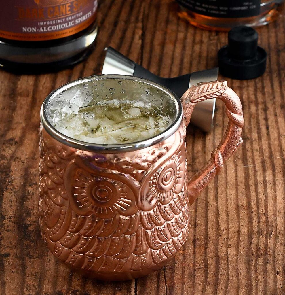 Pumpkin spice cocktail with rum in a bronze owl mug