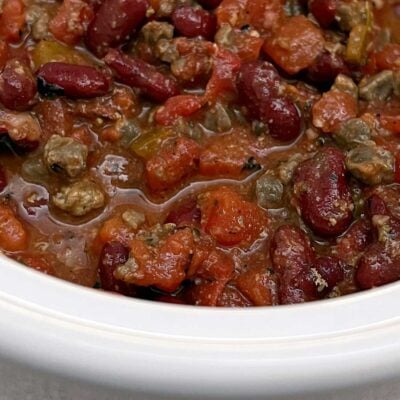 Slow cooker chili in a small white slow cooker.