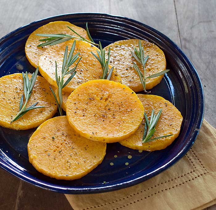 Roasted Butternut Squash on a plate with rosemary on top