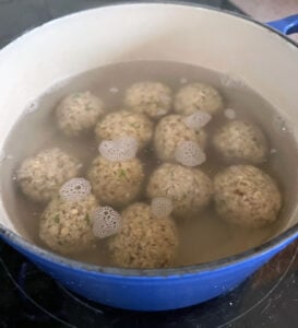 Matzo balls cooking in salted water.
