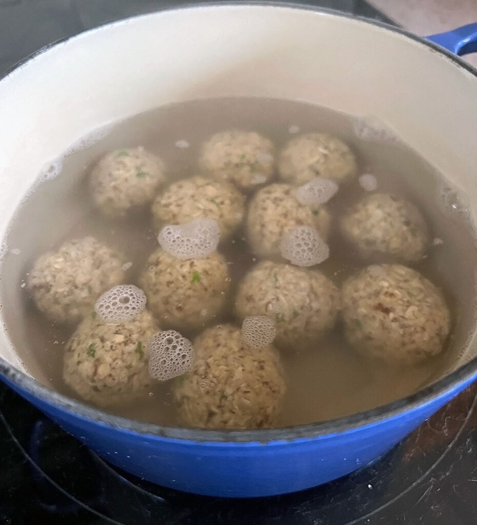 Matzo balls cooking in salted water.